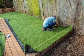 artificial grass installer at work